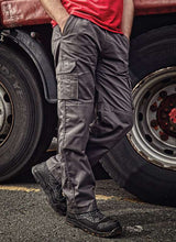 Condor Combat Trouser in charcoal grey worn by worker near truck tire. Durable workwear ideal for uniform, PPE, and B2B branding customization.
