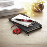 Branded notebooks with pen in context