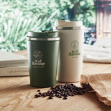 Dark green and Beige tumbler with branding in context