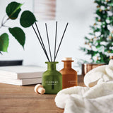 Custom branded Reed Diffusers on wooden table with ICEPEAK logo. Stylish home fragrance for B2B marketing or holiday corporate gifts.