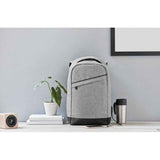 Berlin Laptop Backpack in light grey displayed on a desk setup, highlighting its modern design and USB charging feature for professionals.