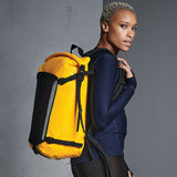 Side angle of yellow backpack being worn by person