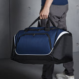 Navy holdall bag being carried