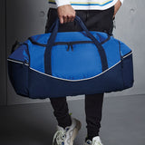 Blue holdall bag being held